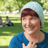 Smiling woman wearing pale mint beanie in the park - Parade Handmade
