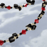 Red and black charm necklace with dyed hematite bead detail  Lapanda Designs - Parade Handmade