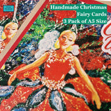 A colorful product cover for a 3-pack of handmade Christmas fairy cards, featuring an illustrated fairy in a red dress with blue wings against a festive background. Text on the cover reads 'Handmade Christmas Fairy Cards 3 Pack of A5 Size'.